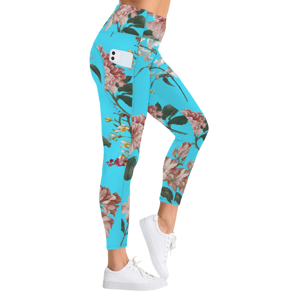 Turquoise leggings with a floral pattern, featuring a side pocket and high-rise waistband, styled with white sneakers.