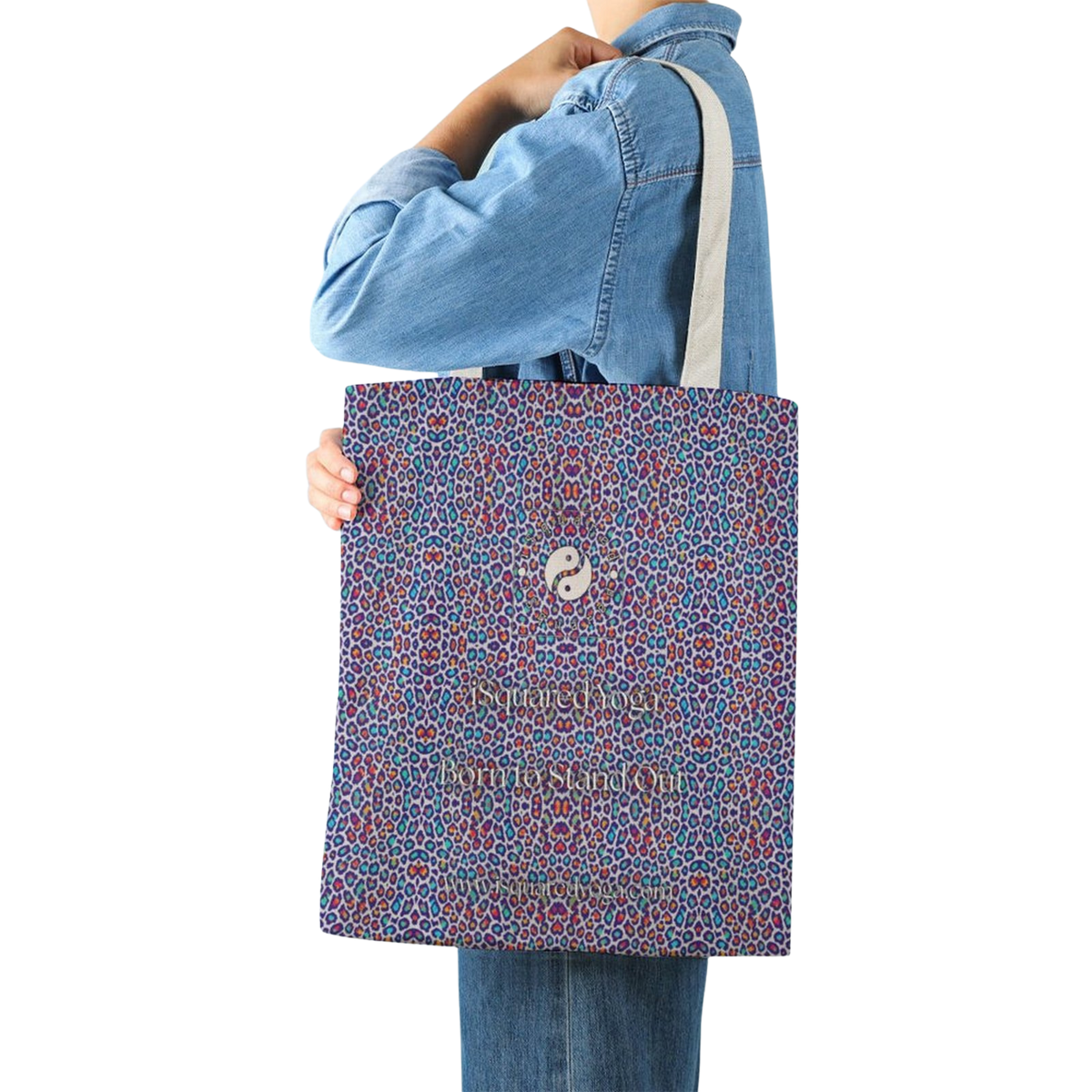Colorful tote bag featuring a wild leopard print design. The bag is held by a person wearing a denim jacket.