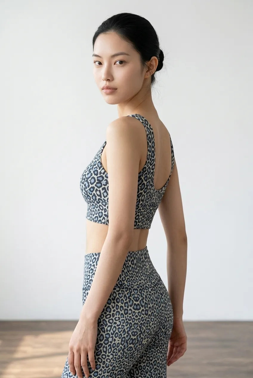 Cropped leopard print top in soft blue and black, featuring a U-back design for a stylish, sporty look.