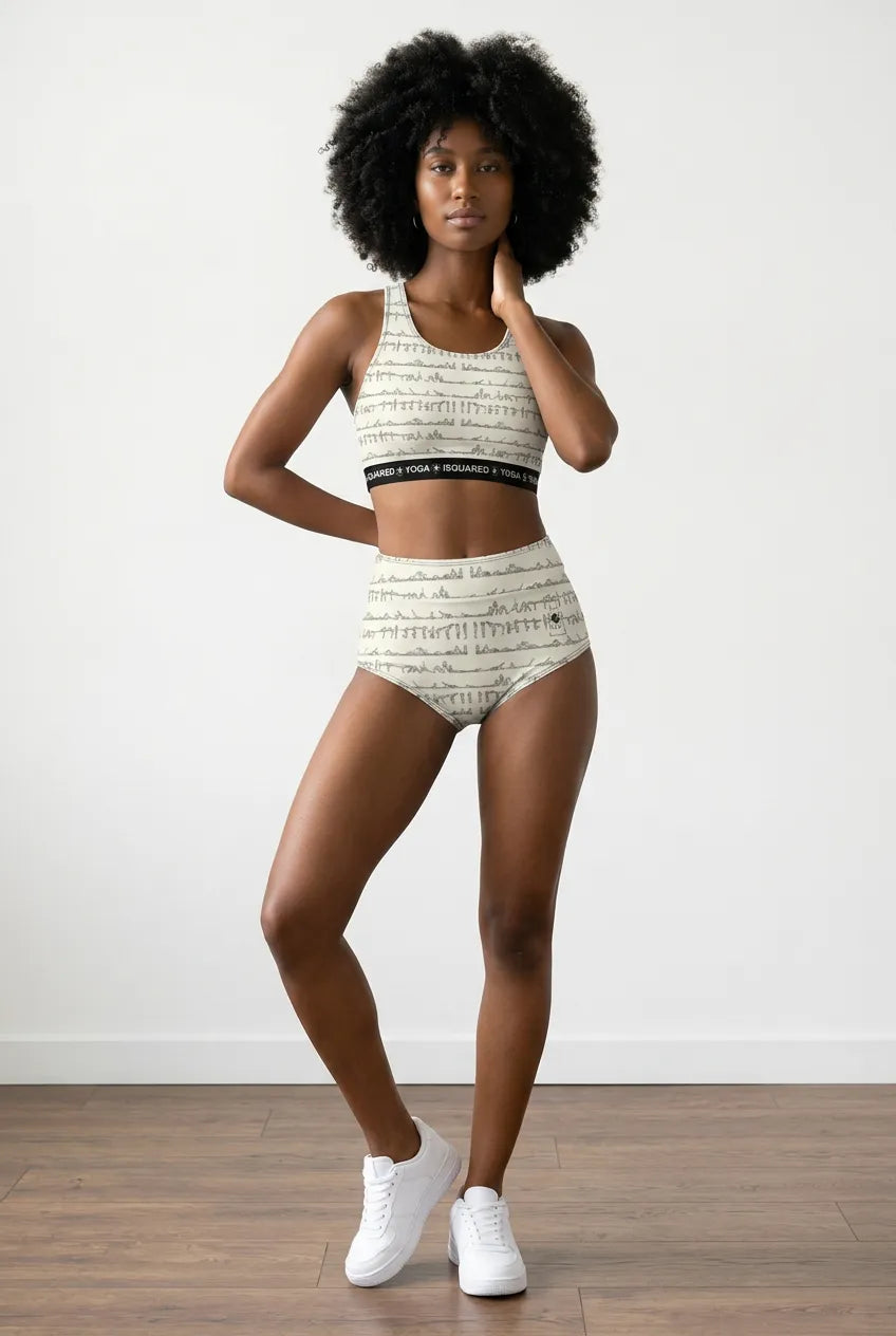 Bikram Series hot yoga bikini set in beige with abstract print; model wears high-waisted bottoms and a cropped sports top.