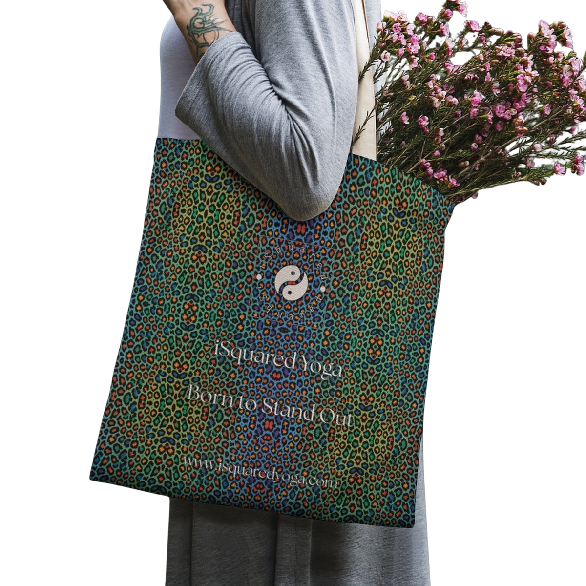 Vibrant multi-colored tote bag featuring a wild leopard print design, held by a model with flowers inside.