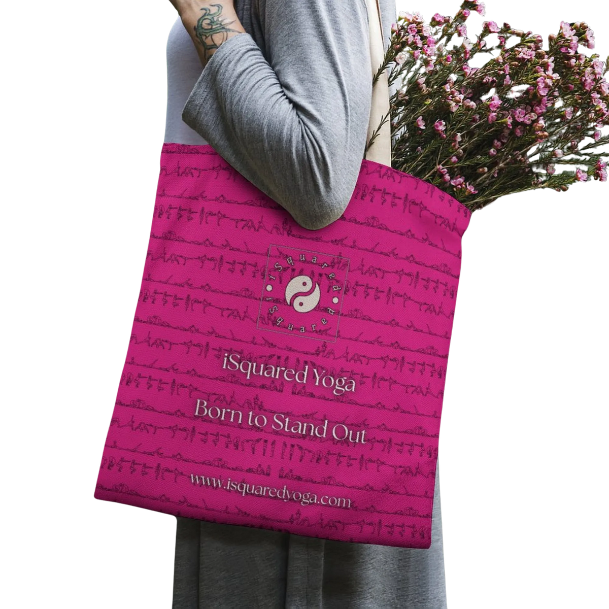 Bright pink tote bag featuring a repeating pattern of yoga postures and the iSquared Yoga logo, carried by a person with flowers.