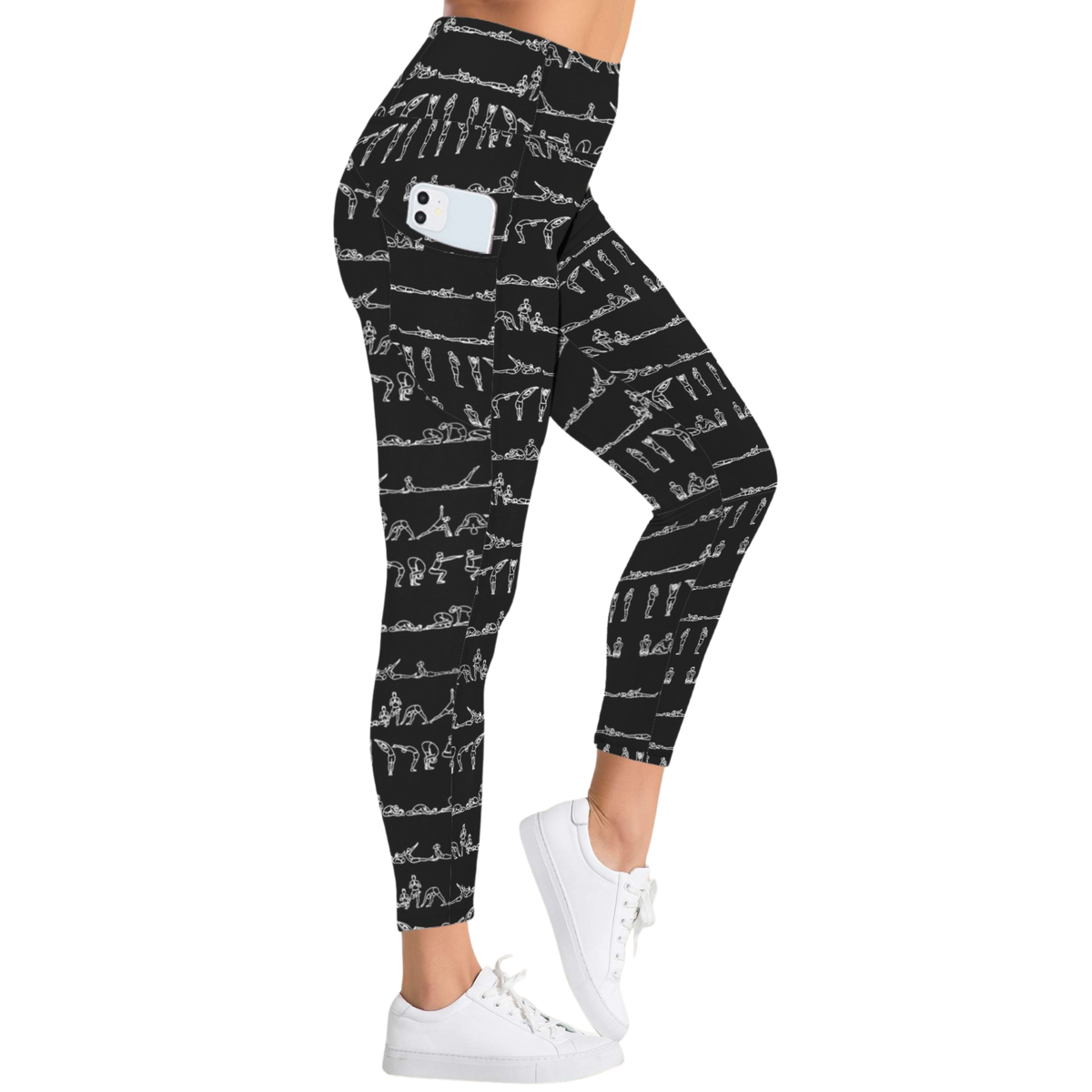 Black leggings with white yoga illustrations, high-rise waistband, featuring side pockets, paired with white sneakers.
