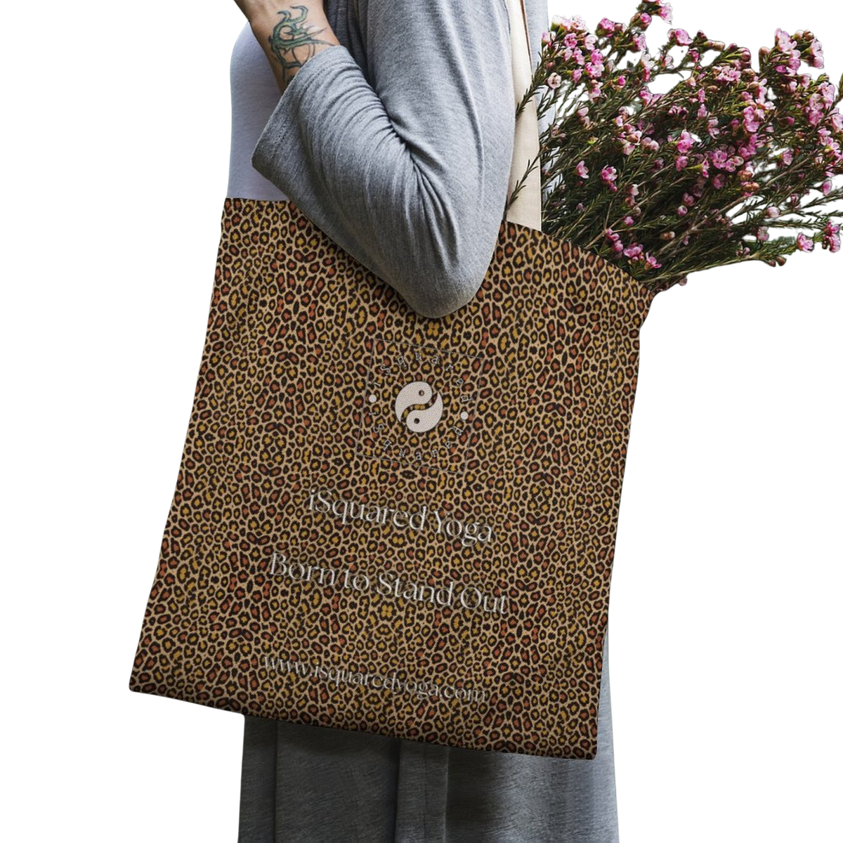 Tote bag featuring a classic leopard print in golden and black, carried over the shoulder with floral contents.