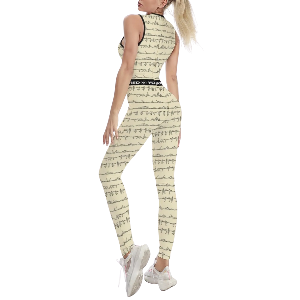 Sleeveless beige jumpsuit with abstract black pattern, form-fitting silhouette, worn with white sneakers.