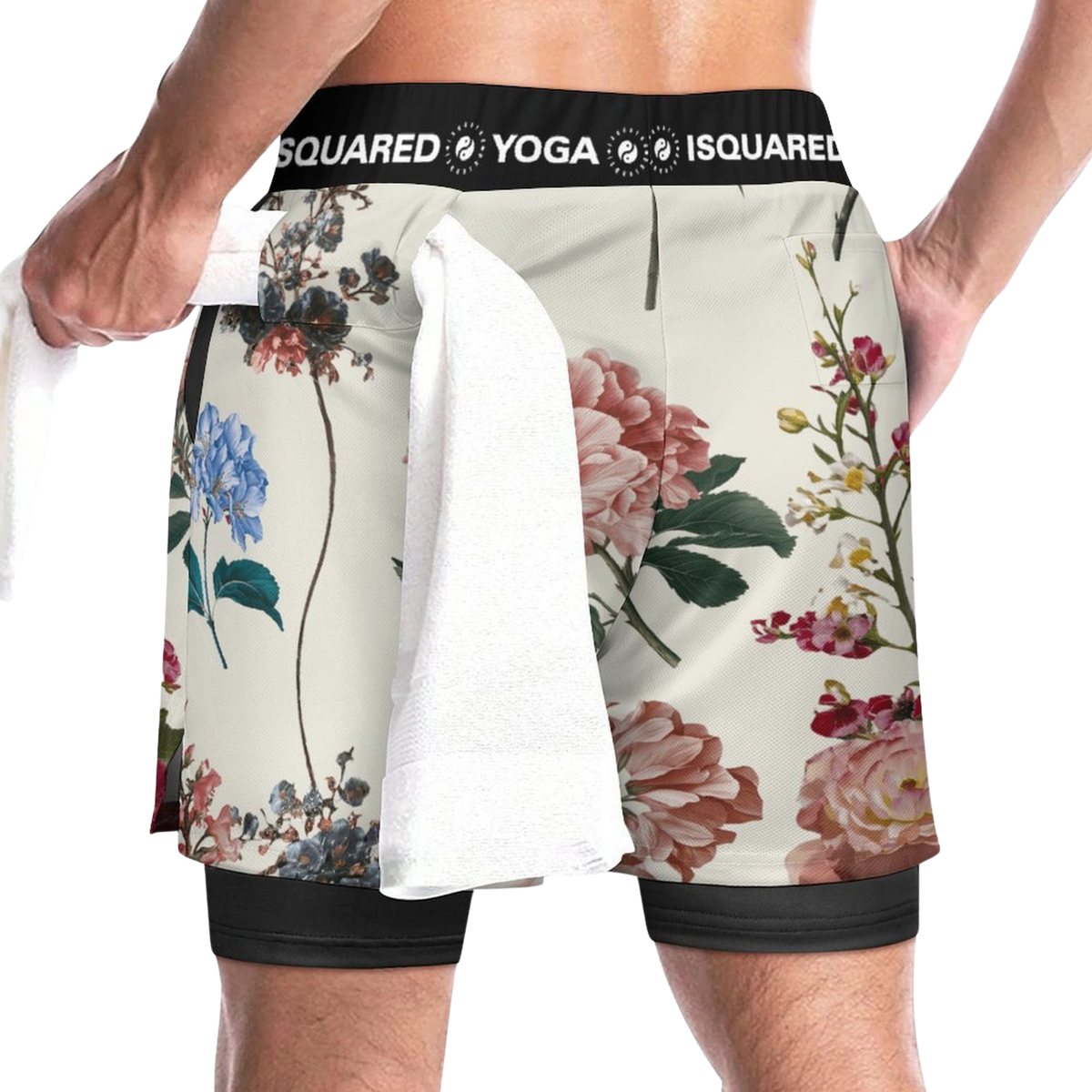 Compression Yoga Shorts featuring a botanical floral pattern in shades of pink, blue, and green, with a black elastic waistband. A white towel hangs from the waist.