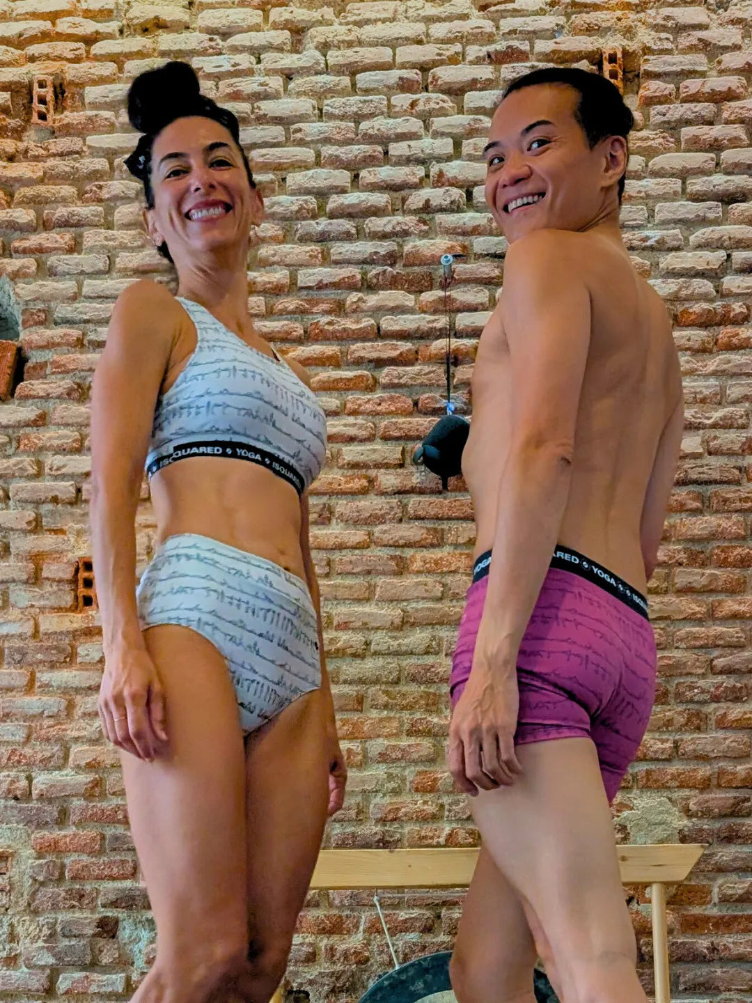Unisex Bikram Series iSquared Yoga Shorts, featuring a line-art print of yoga postures and a black elastic waistband.