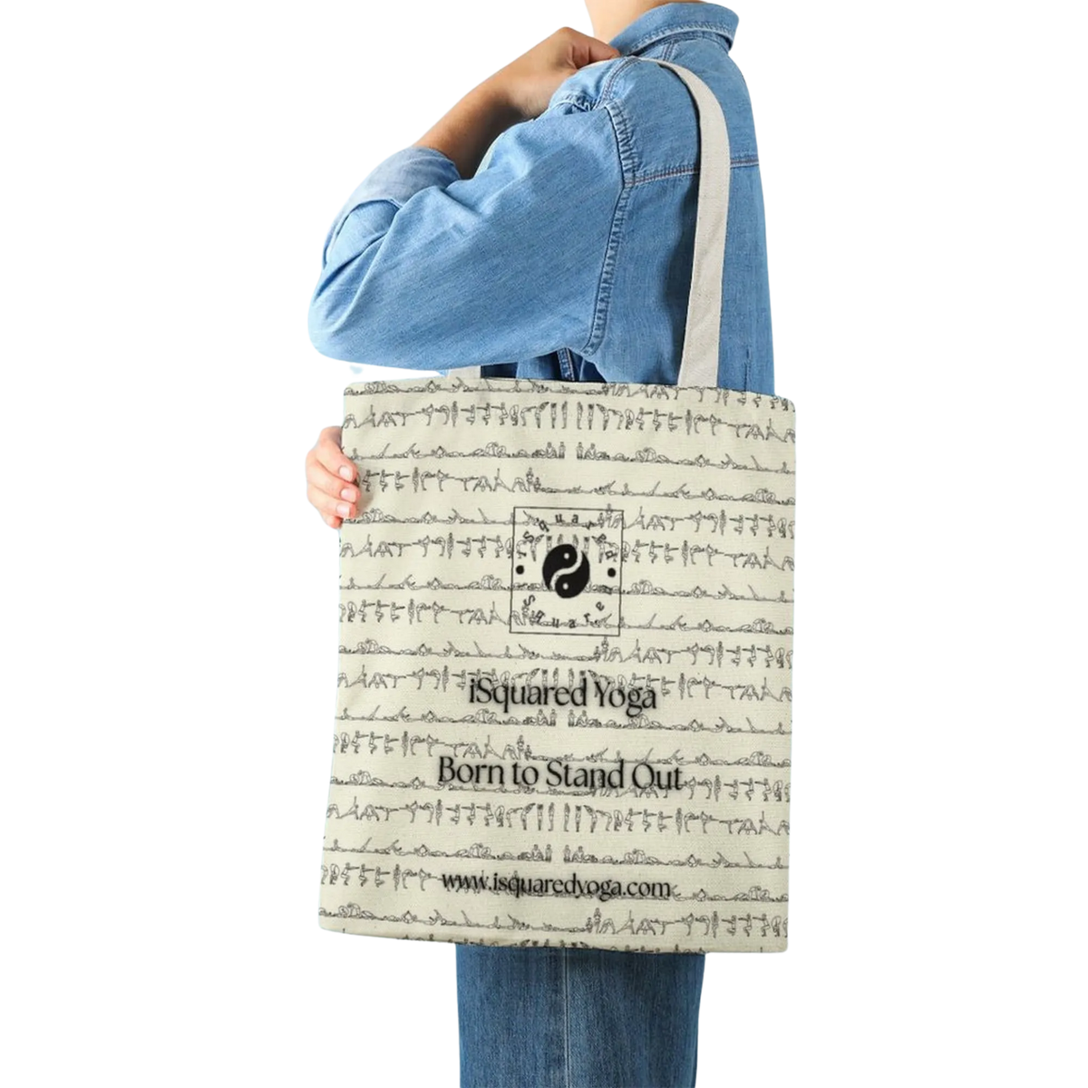 Beige iSquared Tote Bag featuring a yin-yang design and yoga postures, held by a model in a denim jacket.