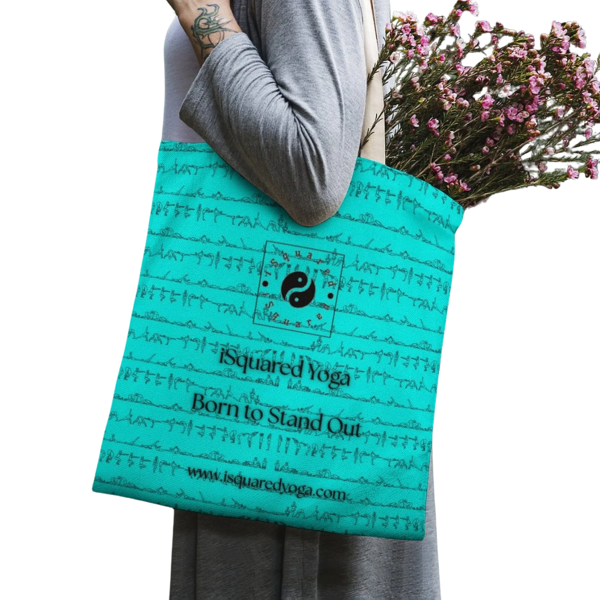 A turquoise iSquared Tote Bag featuring artistic designs and contrasting black text, held by a model carrying flowers.