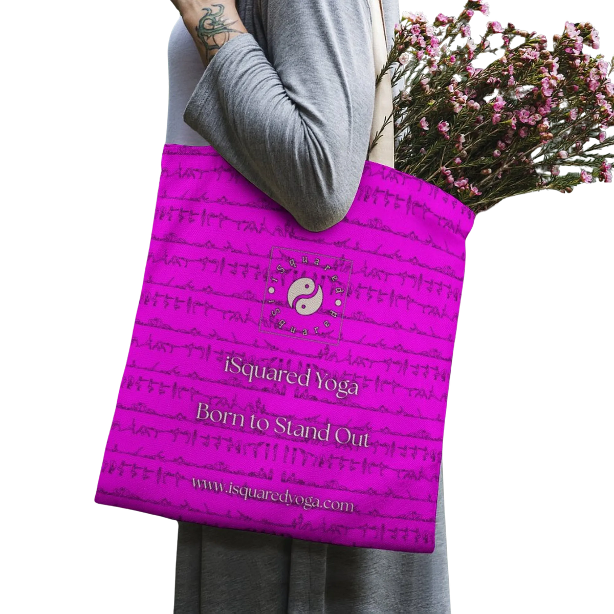 Vivid pink tote bag featuring the iSquared Yoga logo, held by a model wearing a gray top, filled with flowers.
