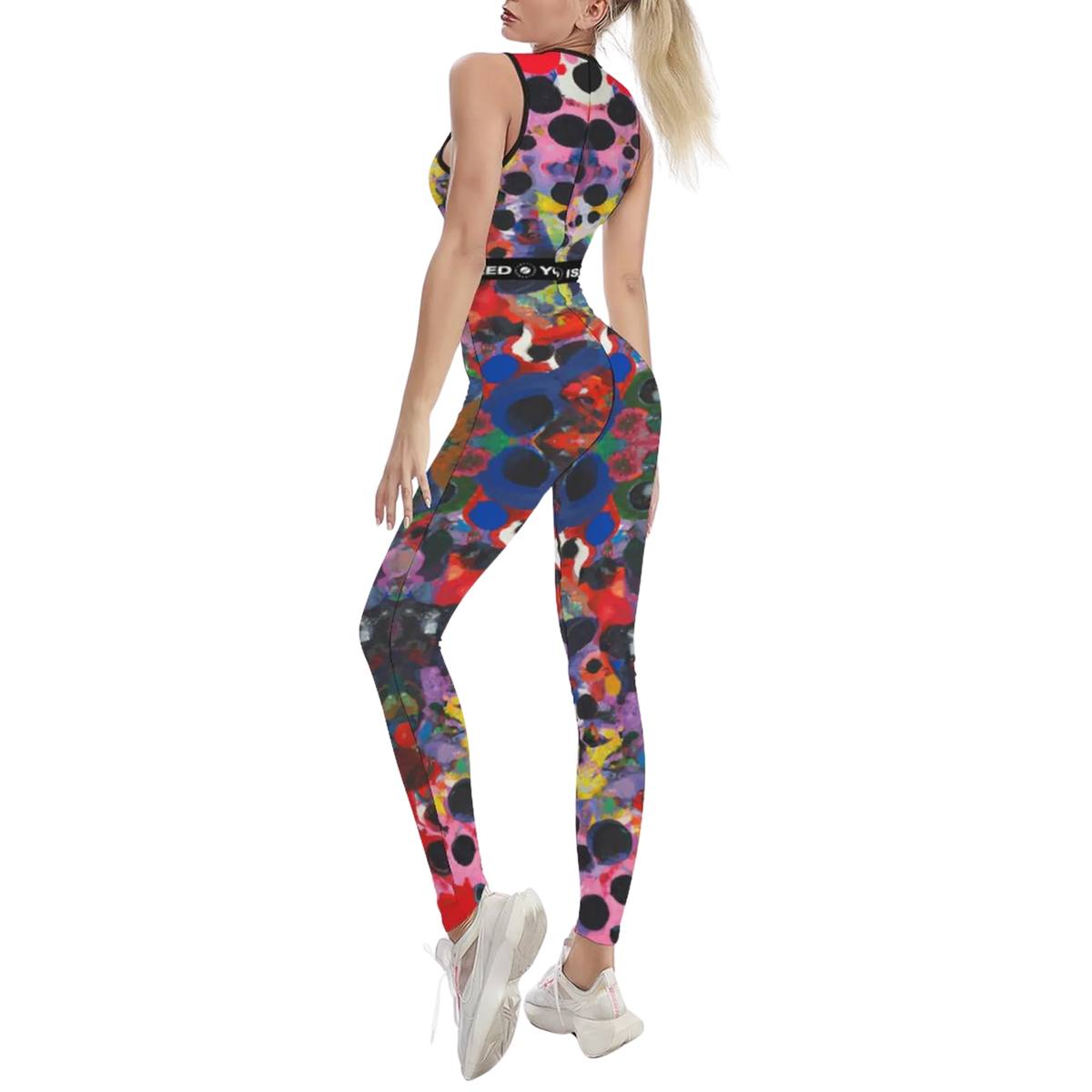 Sleeveless, colorful patterned iSquared jumpsuit featuring a body-contouring fit, worn with white sneakers.