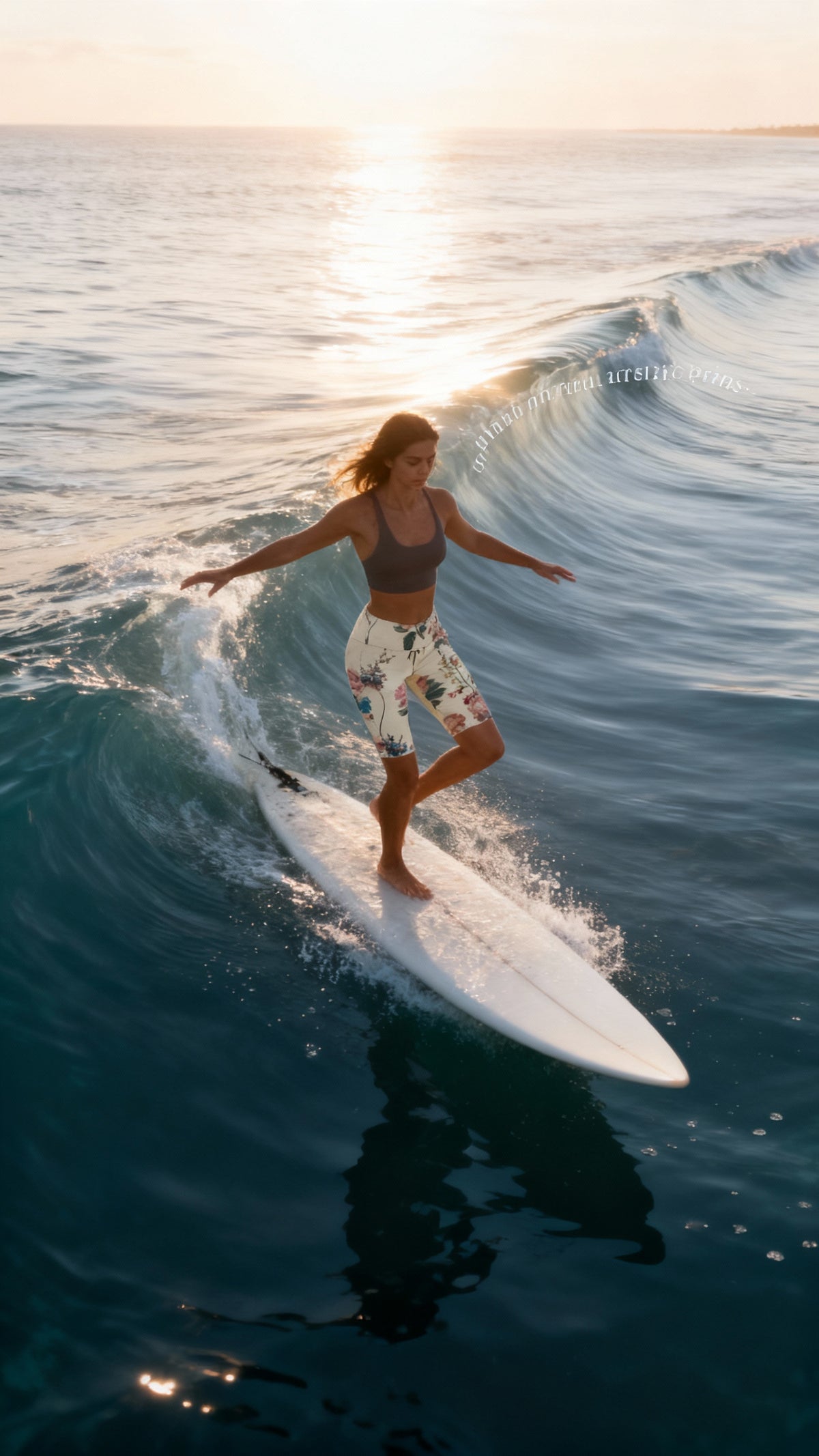 High-waisted, floral-print iSquared Maureen Shorts, worn by a surfer, paired with a simple sports bra. Surfing at sunset.