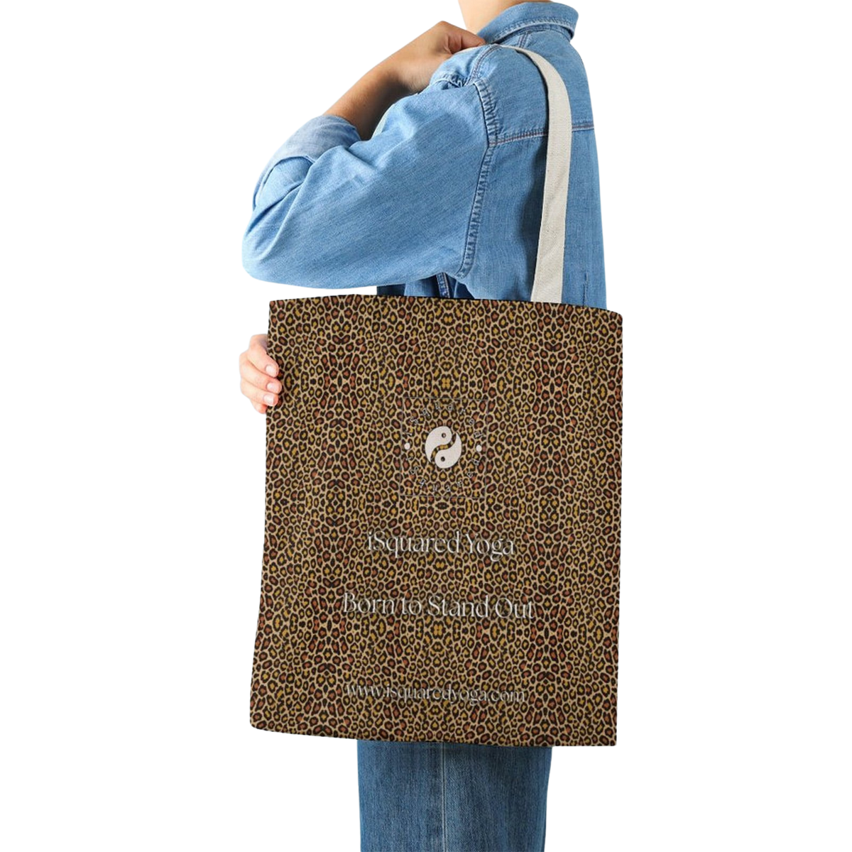 Leopard print tote bag held by a person in a denim shirt, featuring a yin-yang symbol on one side.