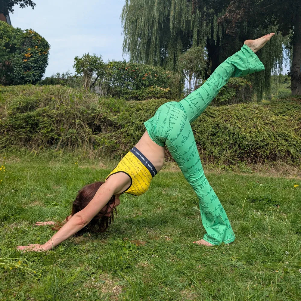 Bikram Series Cross Waisted Flair Leggings in a cream color with black yoga pose prints, featuring a crossover waistband and flare legs.