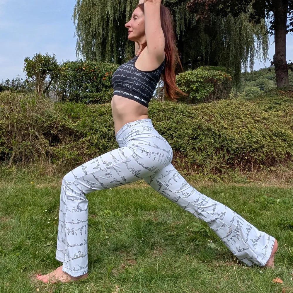 Bikram Series Cross Waisted Flair Leggings in cream with a subtle black yoga posture print, featuring a flattering flare leg design.