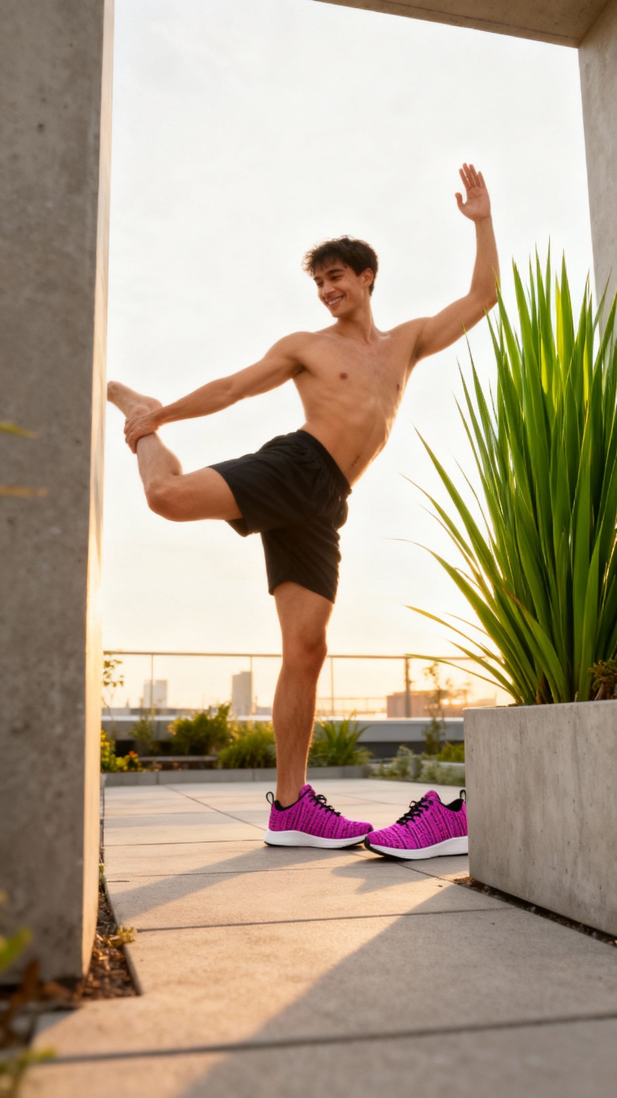 Bright pink iSquared Men Runners with a breathable design, worn by a shirtless man performing a stretching pose outdoors.