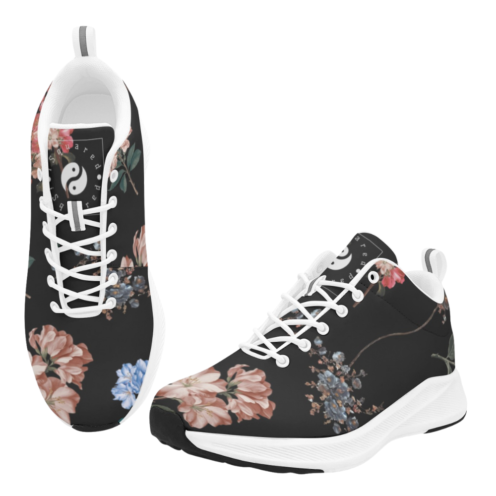 Black athletic shoes featuring a floral pattern with pink and blue flowers, white laces, and a cushioned sole.