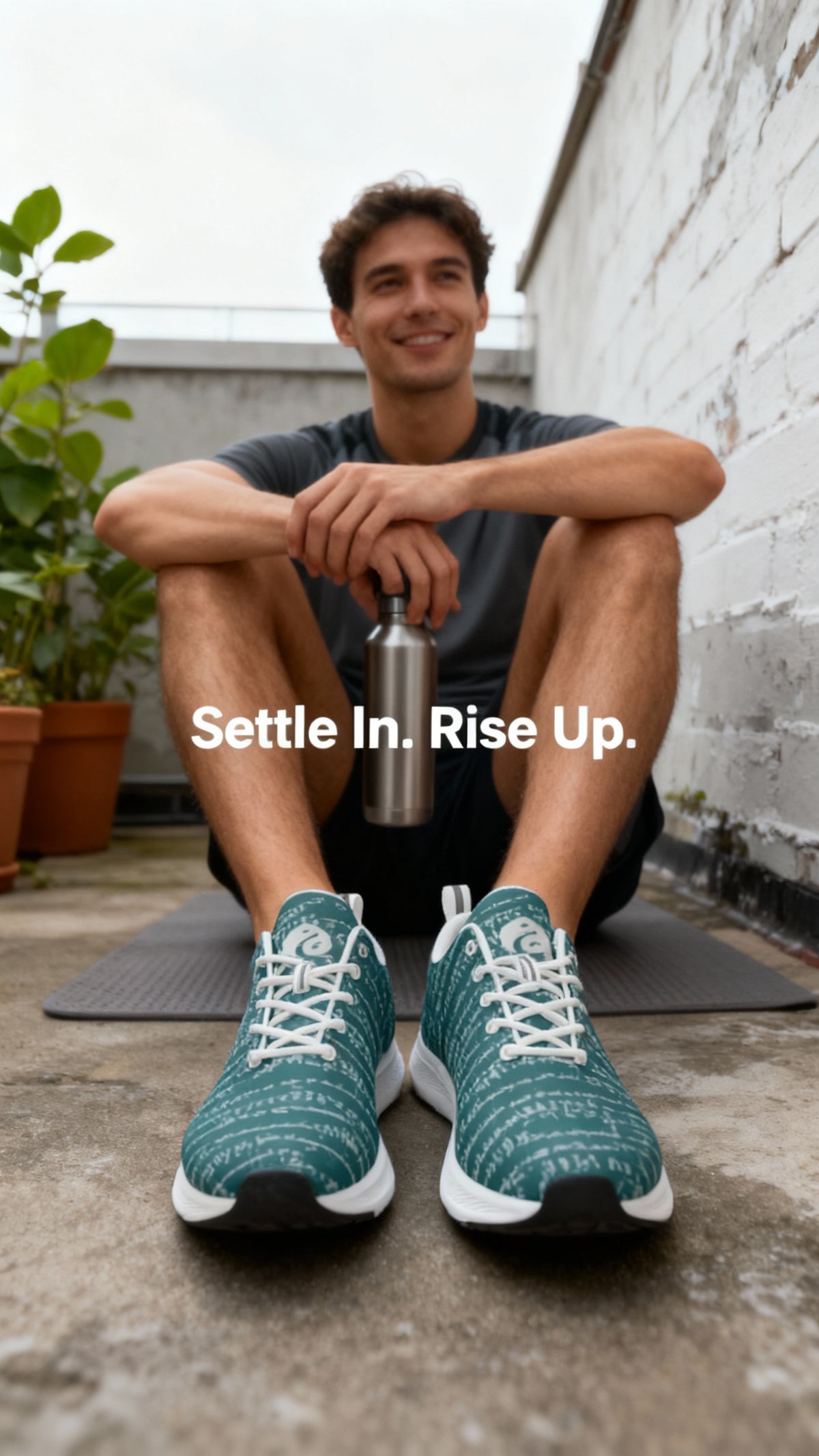 Teal and white iSquared Men Runners with intricate print, worn by a smiling male model sitting on a yoga mat.