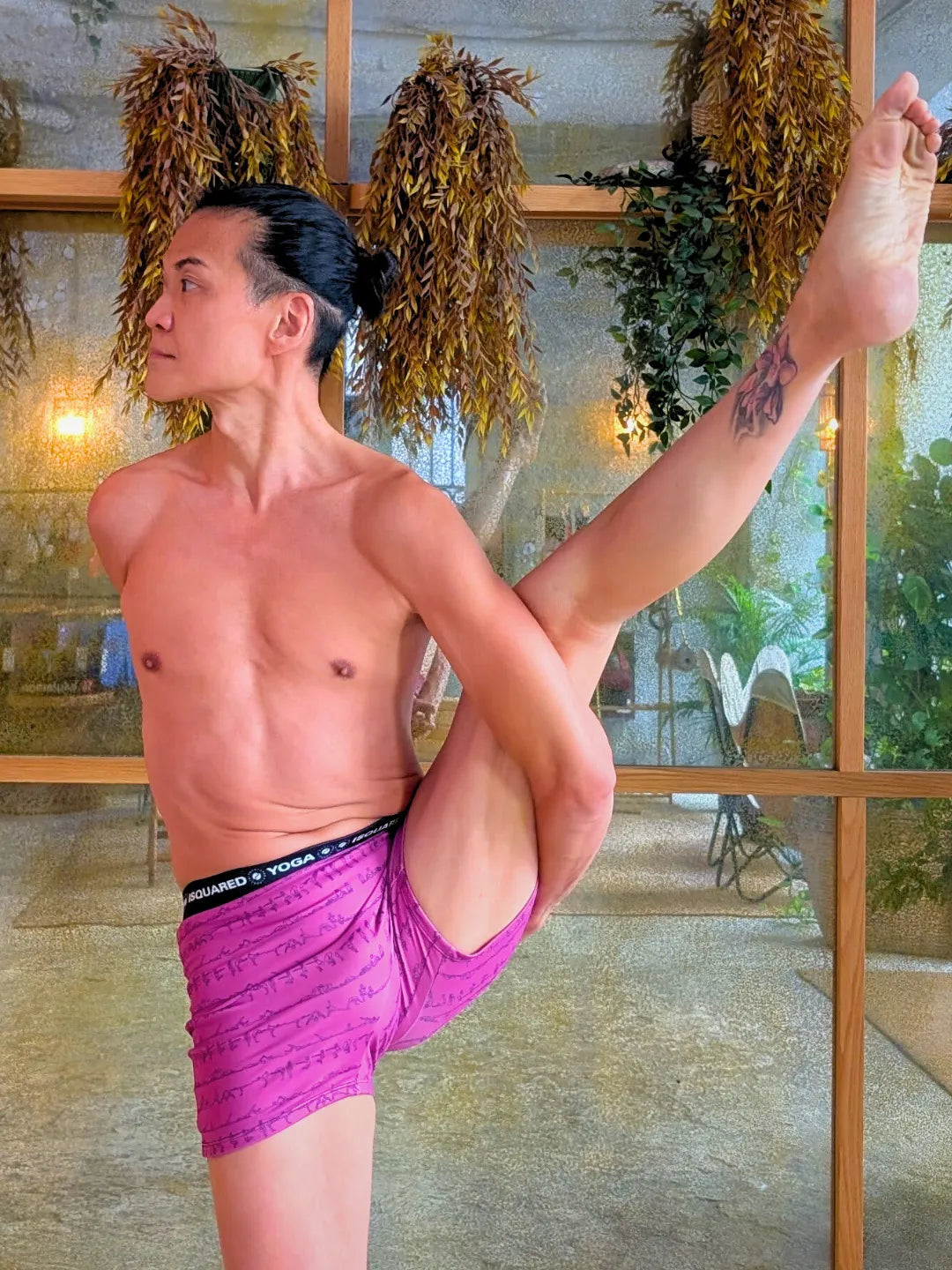 Unisex Bikram Series iSquared Yoga Shorts, featuring a line-art print of yoga postures and a black elastic waistband.