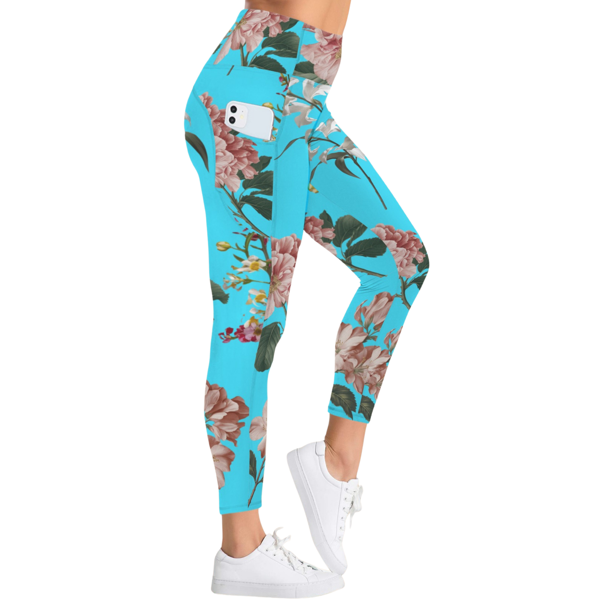 Turquoise leggings with a floral pattern, featuring a side pocket and high-rise waistband, styled with white sneakers.