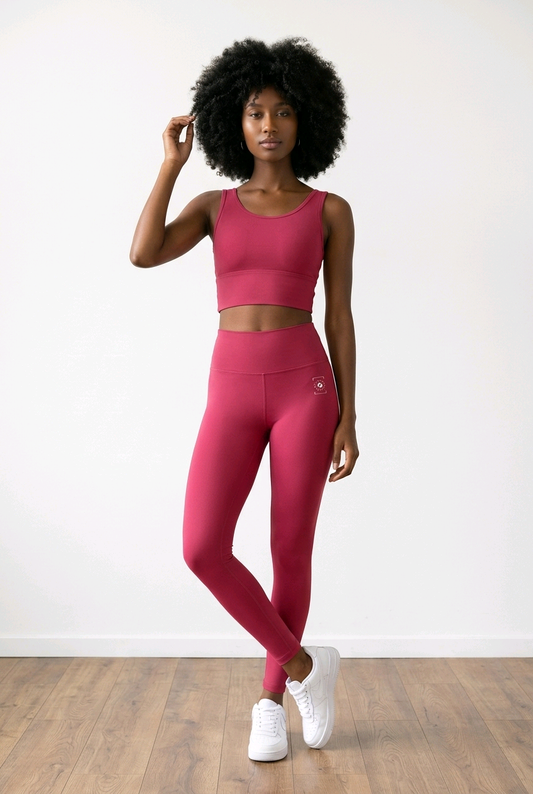 Crimson Pocket Leggings with a high-rise waistband, smooth fit, and side pockets, worn with a matching sports bra.